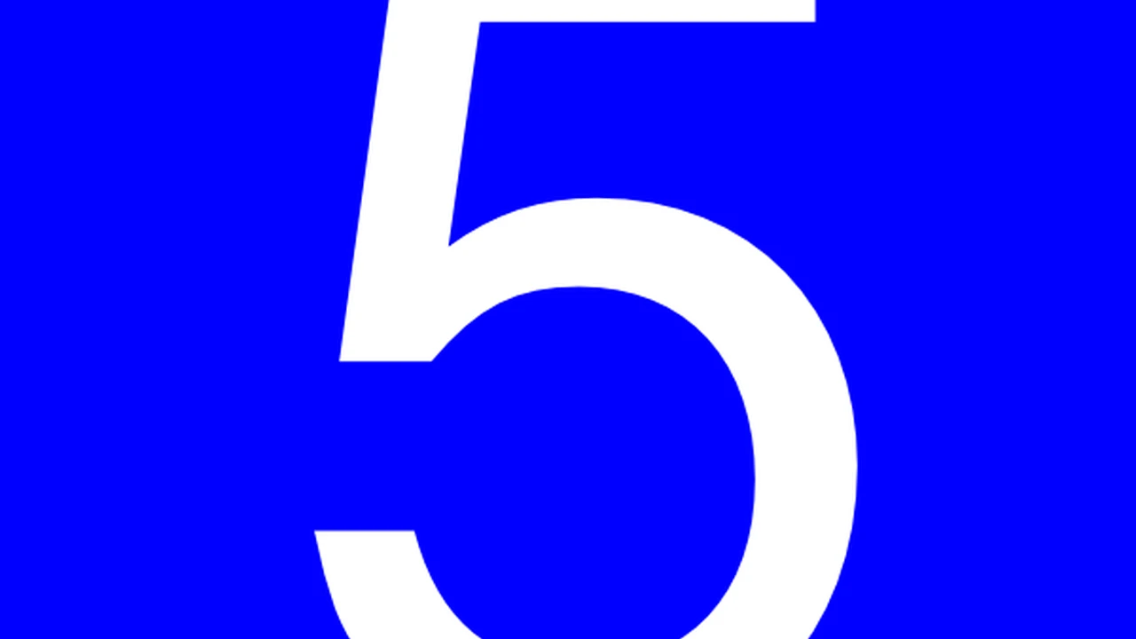 overhead view of corned beef sliced and on a platter with cabbage, potatoes, and carrots