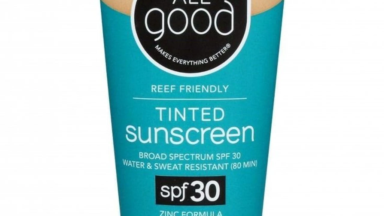 Two mint chocolate milkshakes with whipped cream and green sprinkles.