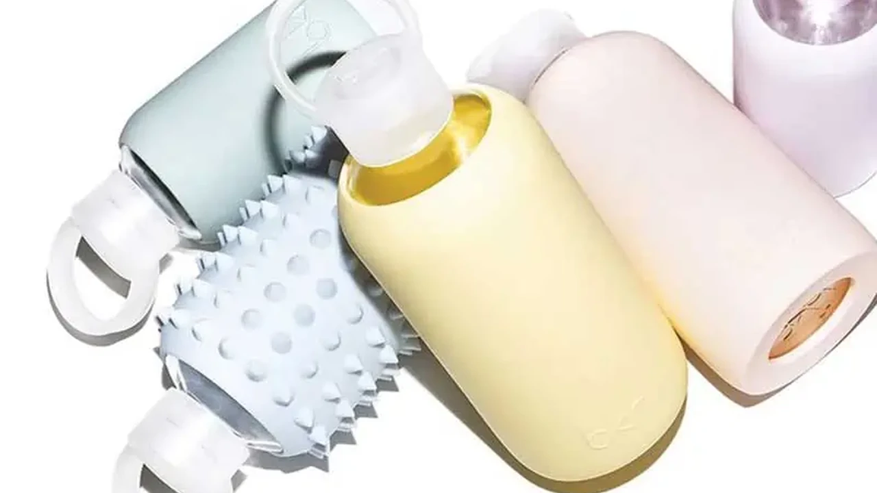 Close up on a plate of mashed potatoes, topped with baked pork chops with cream of mushroom soup, and a side of green beans.