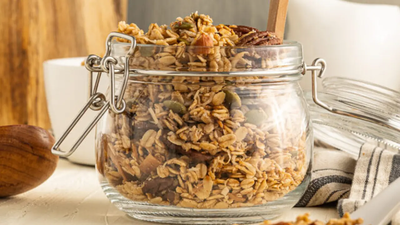 Close up on a plate of mashed potatoes, topped with baked pork chops with cream of mushroom soup, and a side of green beans.