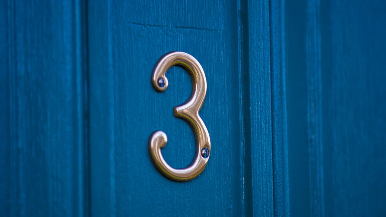 Close up on a plate of mashed potatoes, topped with baked pork chops with cream of mushroom soup, and a side of green beans.