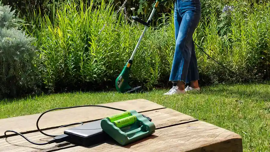 blue bowl of black bean beef tortilla soup on a board with cilantro and shredded cheese in background