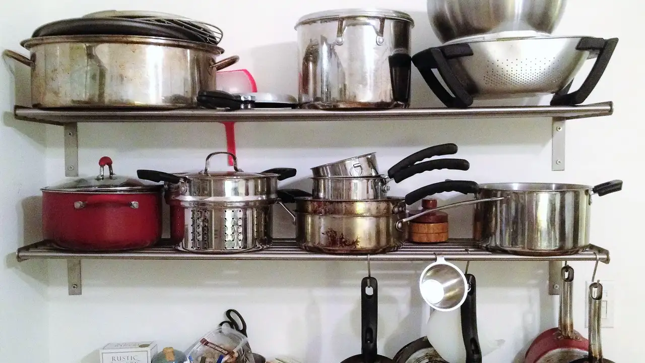 Close up on a plate of mashed potatoes, topped with baked pork chops with cream of mushroom soup, and a side of green beans.